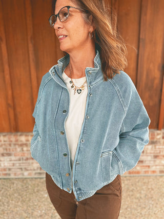 Judy Blue Marty bomber jacket in icy blue, modeled by an A Gathering Place team member