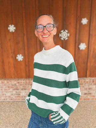 Zenana dark green knit sweater with striped cuffs, modeled by an A Gathering Place team member