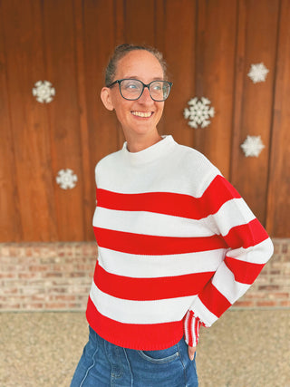 Zenana ruby knit sweater with contrasting striped cuffs, modeled by an A Gathering Place team member