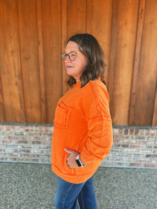 Zenana orange front pocket pullover, side view