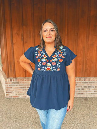 Floral embroidered babydoll blouse with ruffled sleeves