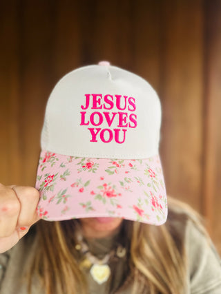 Zenana Jesus Loves You mesh snapback hat in pink floral, modeled by an A Gathering Place team member